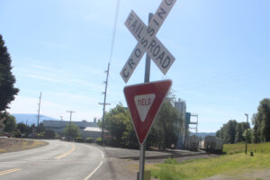 A railroad crossing sign sits in front of the Fitesa building at the Port of Camas-Washougal industrial park on May 27, 2025. (Doug Flanagan/Post-Record)