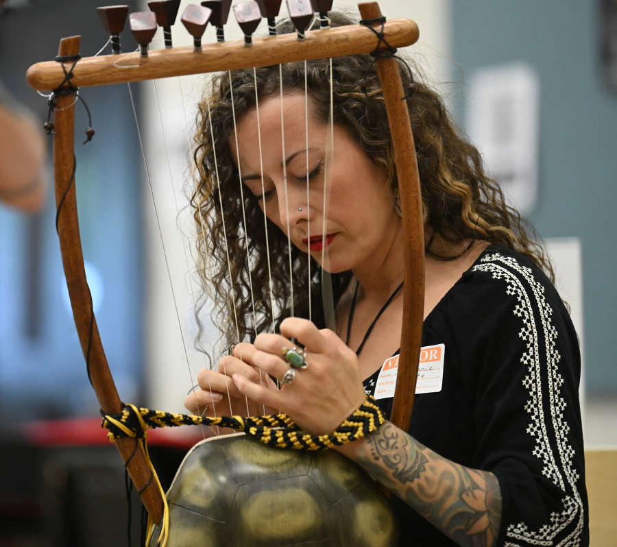 Stephanie Corbell plays a lyre May 6 at Washougal High School. The Corbells run the Washougal Songcraft Festival, which launched in 2022 to promote arts education and celebrate song-writing.