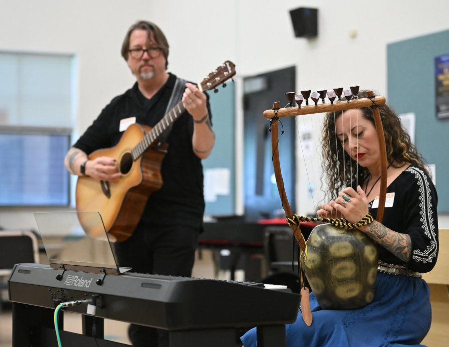 Stephanie, right, and Christopher Corbell perform for students May 6 at Washougal High School. The Corbells run the Washougal Songcraft Festival. (Taylor Balkom/The Columbian)