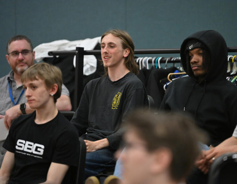 Washougal sophomore Nova Baird, center, asks a question of Stephanie and Christopher Corbell (not pictured) on May 6 at Washougal High School. The Corbells run the Washougal Songcraft Festival.