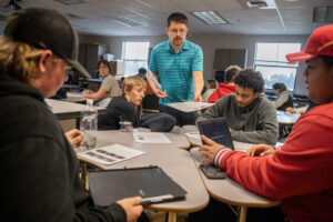 Washougal High School teacher William Baur, center, hands out worksheets to students in a sophomore biology class on May 15 at Washougal High School. Baur is a nominee for the Presidential Award for Excellence in Math and Science Teaching. (Taylor Balkom/The Columbian)