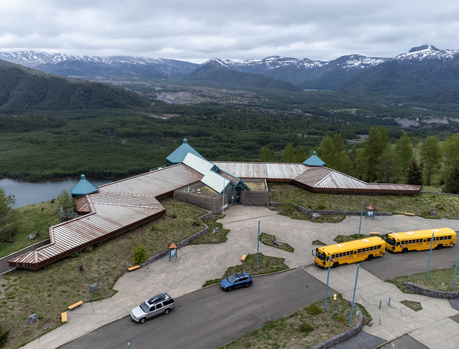 School buses park in front of the Mount St. Helens National Volcanic Monument Science and Learning Center at Coldwater on May 23, 2023. The nonprofit Mount St. Helens Institute uses the building to conduct youth education programs. (Taylor Balkom/The Columbian files)