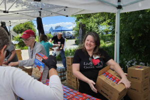 Duwayne Dockter, left, and Kim Horner supervise food-box packing during the 2024 Impact Camas-Washougal food drive. (Contributed by Beth Raetz)