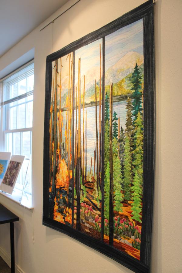 Artist Judith Phelps’ “From the Ashes” art quilt hangs inside the Second Story Gallery in downtown Camas on Friday. The piece is one of several art quilts displayed at the Camas library gallery throughout the month of June as part of the gallery’s Storyteller Quilters’ art show. (Kelly Moyer/Post-Record)