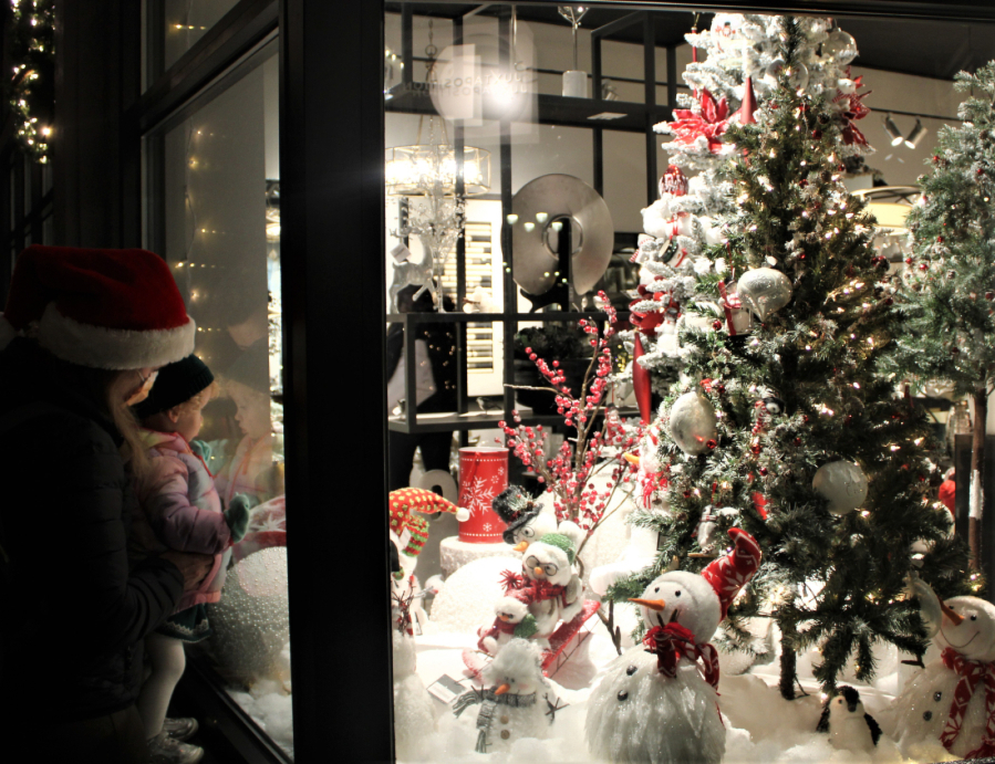 A family admires holiday displays inside the Juxtaposition home furnishings shop in downtown Camas during the city of Camas’ 2021 Hometown Holidays event Dec. 3, 2021. (Kelly Moyer/Post-Record files)