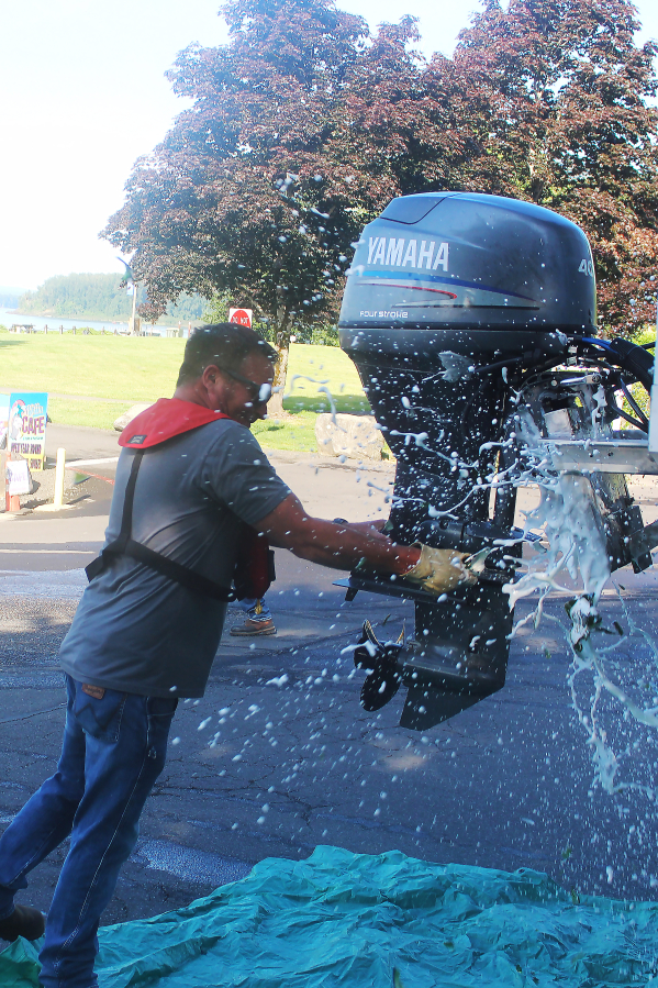 Port of Camas-Washougal Facilities Director Eric Plantenberg smashes a bottle of sparkling wine on the port&rsquo;s new boathouse at Parker&rsquo;s Landing Marina on June 6.