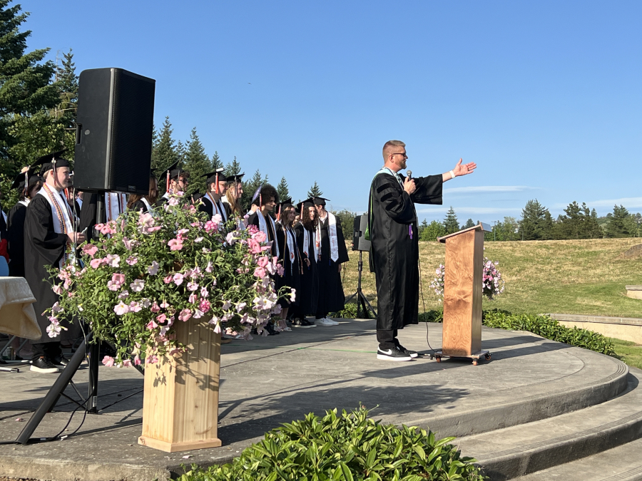 Discovery High School Principal Dan Huld gestures toward a crowd during the school’s commencement ceremony for the class of 2025 on Thursday. (Courtesy of Doreen McKercher, Camas School District)