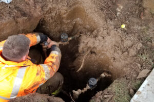 The city of Washougal’s water supervisor Adam Connolly installs a new water meter in an undated photo. (Courtesy of the city of Washougal)