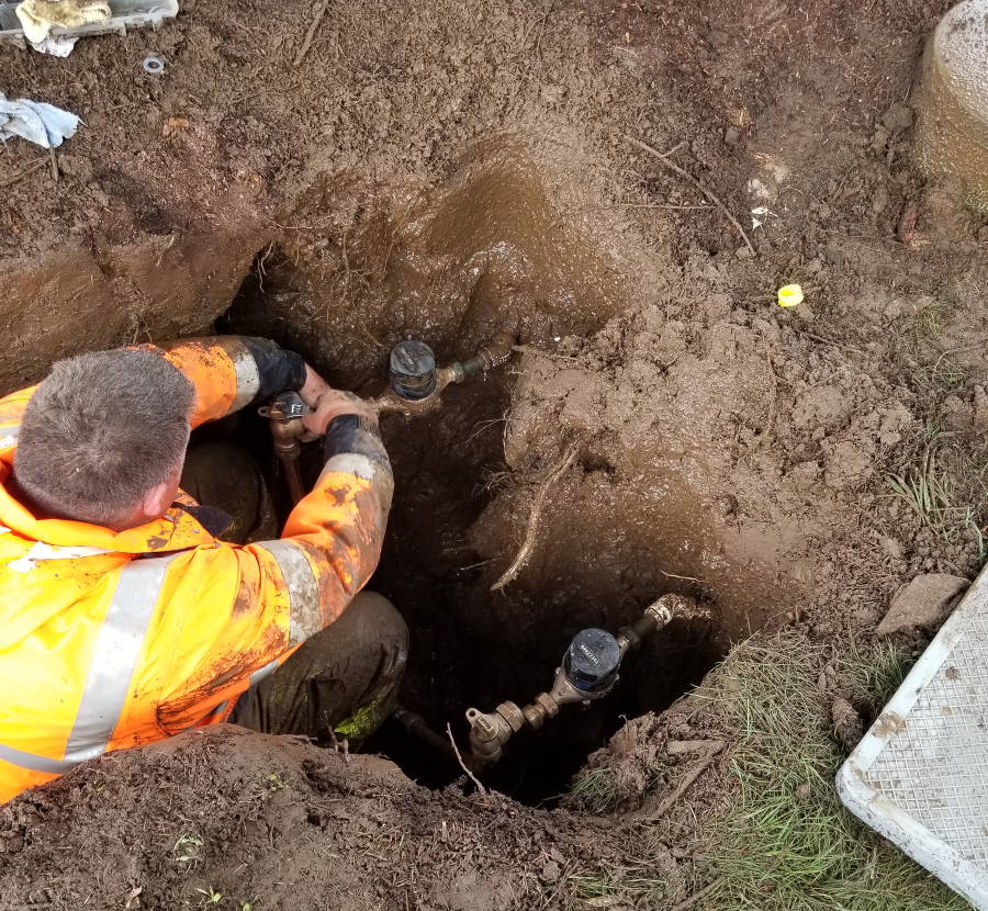 The city of Washougal’s water supervisor Adam Connolly installs a new water meter in an undated photo. (Courtesy of the city of Washougal)