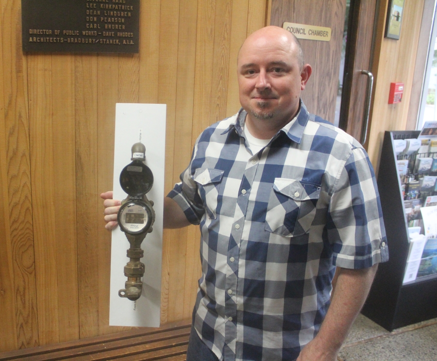 City of Washougal employee Chris Tarr holds a mock-up of the city’s new water meters at City Hall on June 13, 2025. (Doug Flanagan/Post-Record)