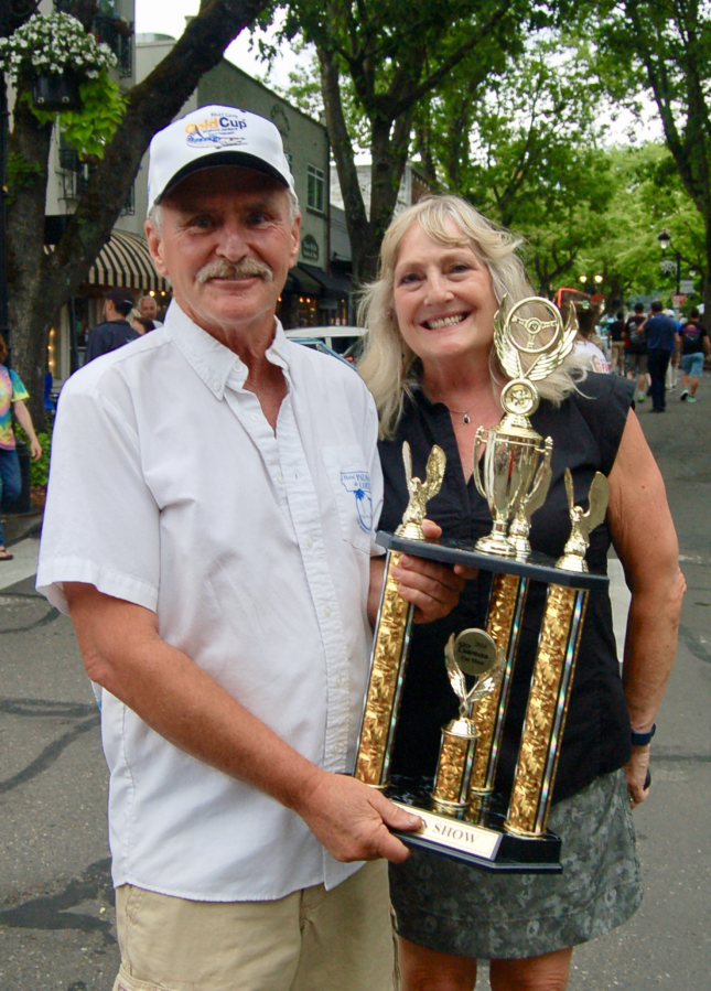 Jerry and Mary Sauer, of Camas, hold the Best in Show trophy they won for their 1970 Plymouth Cuda during the 2024 Camas Car Show, held June 29, 2024.