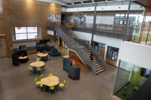 Discovery High School students gather in the east commons area of their project-based learning high school in Camas on Thursday afternoon, May 22. To make up for a $13 million revenue shortfall, the Camas School District is merging its two project-based learning schools, bringing Odyssey Middle School students and staff into the adjacent Discovery High School building this fall to create the district’s first 6-12 school. (Photos by Amanda Cowan/The Columbian)