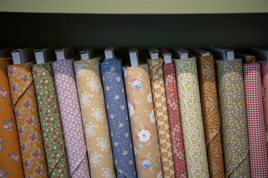 Reams of quilting fabric sit on a shelf Friday at Fiddlesticks Quilt Shop in Vancouver. (Taylor Balkom/The Columbian)