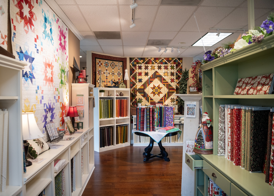 Fabric and quilts sit in retail space Friday at Fiddlesticks Quilt Shop in Vancouver. (Taylor Balkom/The Columbian)