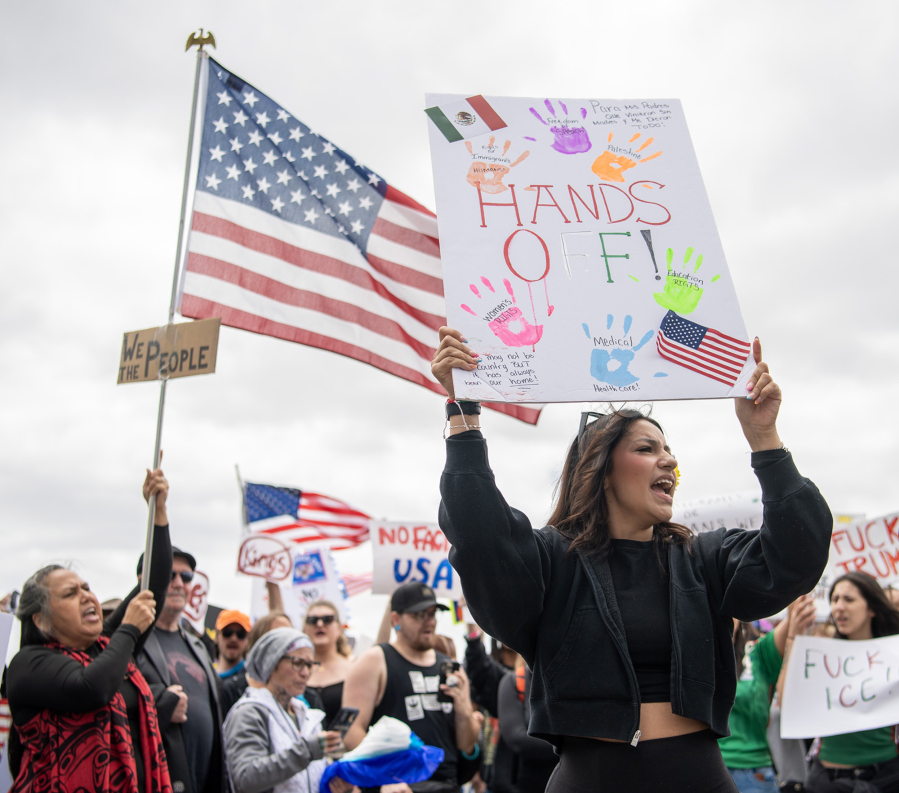 Protesters chant and wave signs Saturday, June 14, 2025, at the Vancouver waterfront during the nationwide “No Kings” rally.