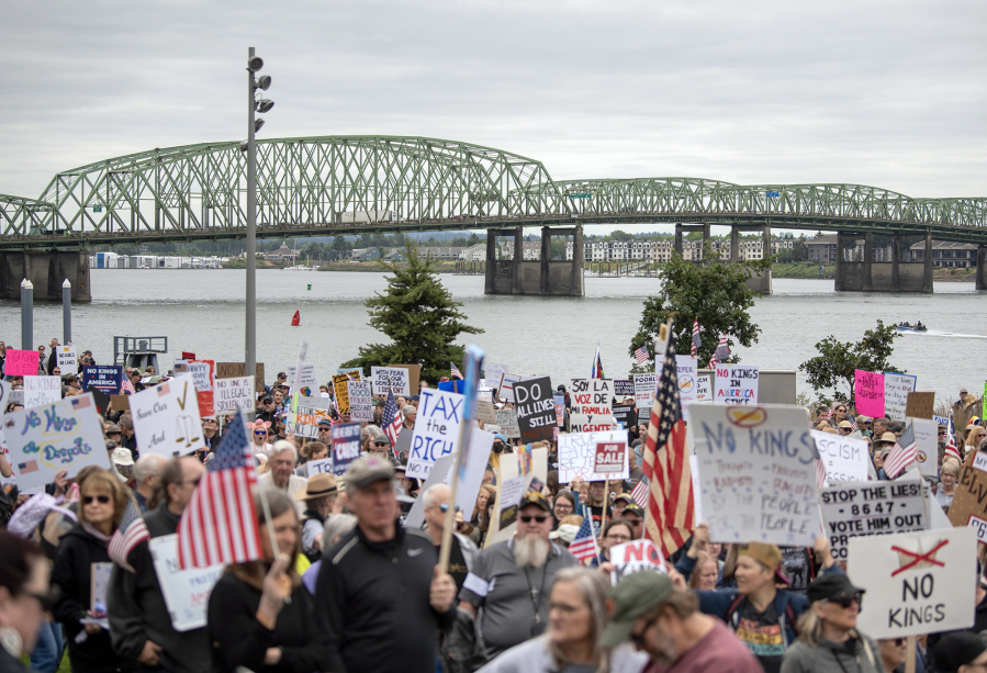 The Interstate 5 Bridge crosses the Columbia River behind a large crowd of protesters participating in the nationwide “No Kings” rally on Saturday on Waterfront Way at the Vancouver waterfront. (Photos by Taylor Balkom/The Columbian)