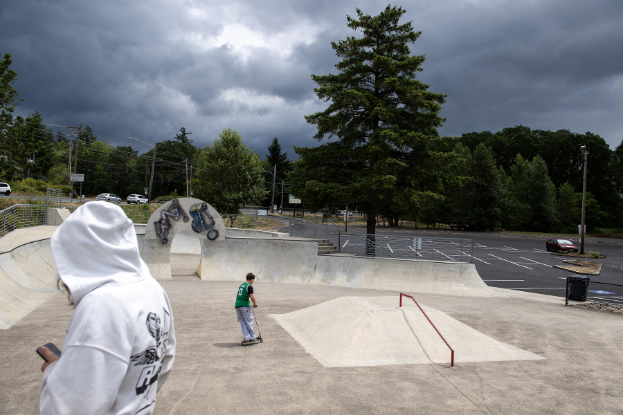 Young people ride scooters and skateboards at Riverside Bowl Skate Park in Camas on Friday, June 20, 2025. Concerns over recreational vehicles illegally parking and leaking fluids in the skate park’s parking lot have prompted Camas city officials to pass a citywide ordinance regulating RV and trailer parking, storage and occupancy on public and private properties. (Amanda Cowan/The Columbian)