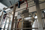 A Grains of Wrath sign hangs from a rail at the brewery&rsquo;s production facility in Washougal. (Contributed by Kindred Media Company)