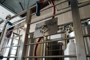A Grains of Wrath sign hangs from a rail at the brewery’s production facility in Washougal. (Contributed by Kindred Media Company)