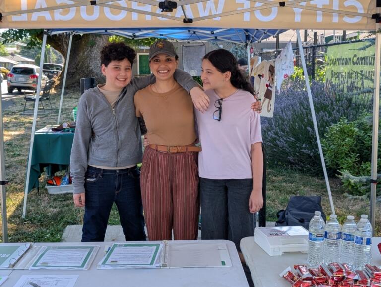 Corinthia Barnhart, the city of Washougal&rsquo;s parks and cemetery manager, poses for a photo with her sons Titus and Lotus during the city of Washougal&rsquo;s first Parks Passport event at the Washougal Community Garden on July 12.