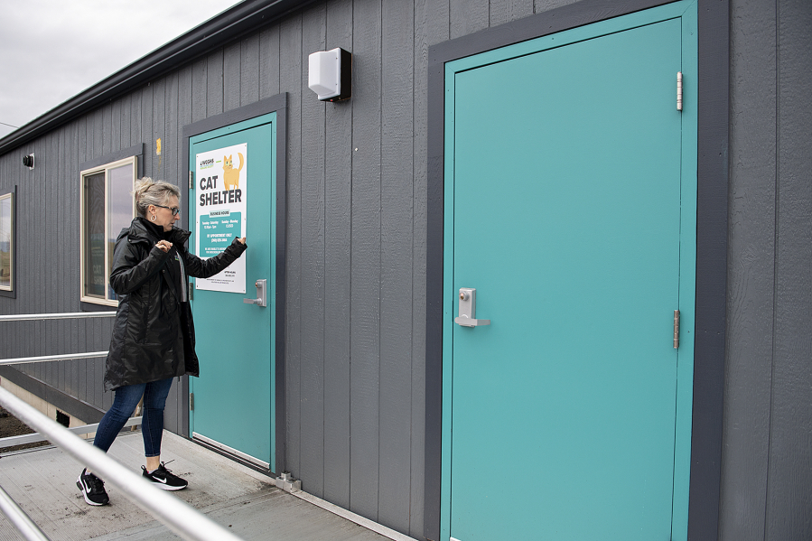 West Columbia Gorge Humane Society Executive Director Micki Simeone knocks on the front door of the organization’s cat shelter in 2023 in Washougal. (Amanda Cowan/The Columbian files)