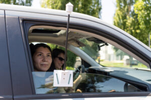 Volunteer Almendra Velazquez, left, installs a heat-measuring sensor on a car window as part of the Heat Watch effort on July 12, 2024. Rebecca Small, right, drove around Clark County measuring heat data by car. (Taylor Balkom/The Columbian files)