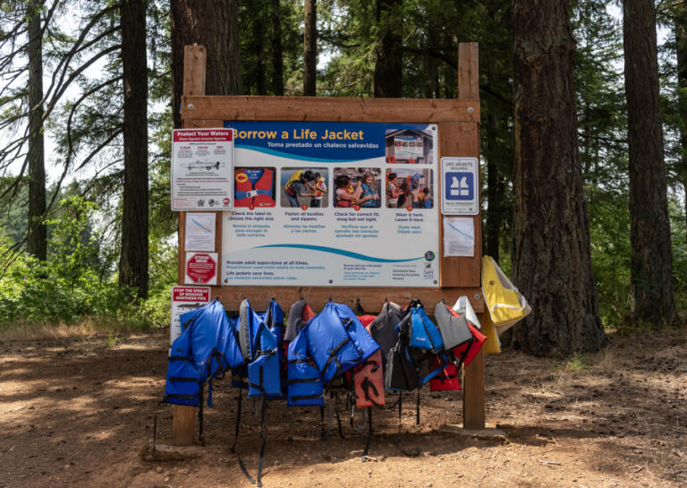 Life jackets hang on a sign June 24 at Lacamas Lake in Camas.
