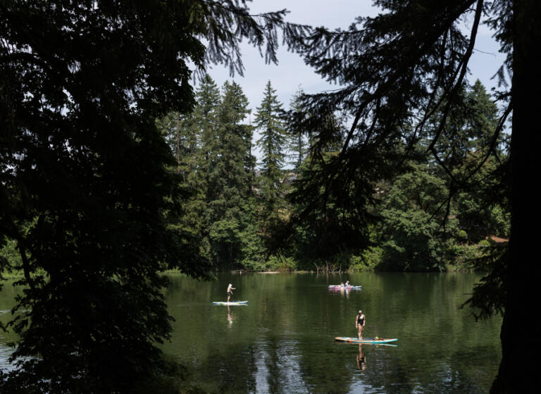 Paddleboarders and kayakers recreate June 24 at Round Lake in Camas.