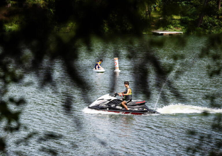 A jet ski slowly motors by June 24 at Lacamas Lake in Camas.
