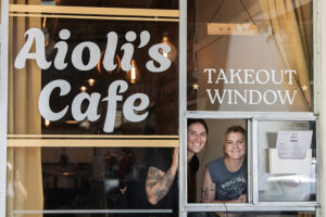 Kara Hendrie, left, and Emma Albertini take a break at Aioli’s Cafe in downtown Washougal on July 3. The cafe, operated through a takeout window on the south side of Miere Catering at 1801 Main St., offers breakfast bowls, sandwiches and more. (Photos by Amanda Cowan/The Columbian)