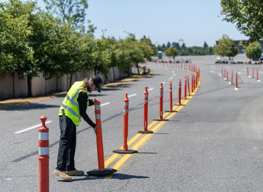 Will Matzka moves cones to prepare for a concert at the Cascades Ampitheater on Tuesday at the Clark County Event Center at the Fairgrounds. (Taylor Balkom/The Columbian)