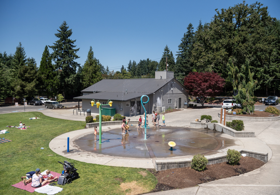 Kids enjoy a summer day Tuesday at the Holley Park splash pad in La Center. “Summers are getting warmer, and we’re hearing from the community that safe, accessible opportunities for water recreation are increasingly a priority,” Kaley McLachlan-Burton, spokeswoman for Clark County Public Works, wrote in an email. (Taylor Balkom/The Columbian)