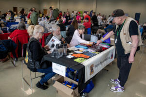 Veteran Gene Trowbridge, right, picks up a free bandana while attending the 2024 Stand Down resource event at the Armed Forces Reserve Center in Vancouver. (Amanda Cowan/The Columbian files)
