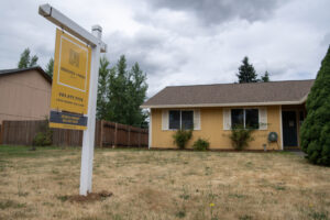 A house for sale sits earlier this summer in Vancouver. Mortgages account for the bulk of household debt nationally, according to federal data. (Taylor Balkom/The Columbian files)