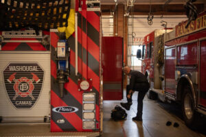 Camas-Washougal Fire Department Capt. James Tierney gears up at Fire Station 42 in Camas. The cities have run a joint fire department for 12 years, but leaders would rather create a regional fire authority. (Taylor Balkom/The Columbian files)