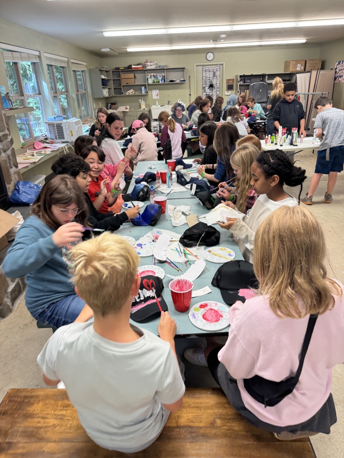 Gales Creek Camp campers paint trucker hats with the help of Washougal artist Susan Fronckowiak (not pictured) in Gales Creek, Ore., on July 29.