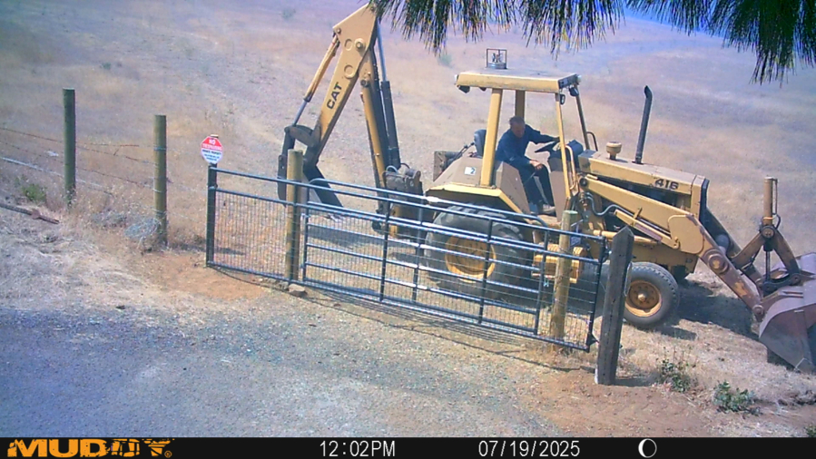 Charlie Deach creates fire breaks around the Columbia Grange Hall near Lyle as the Burdoin Fire burned through the area in July. At right, fire burns toward the Grange hall. (Photos contributed by the National Grange)