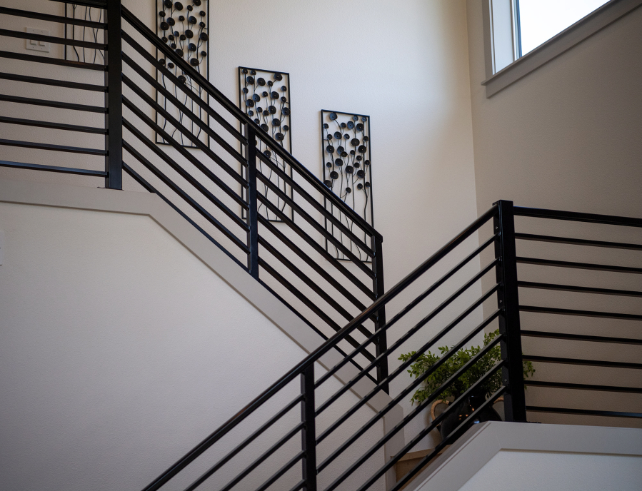 Railings border a staircase Tuesday, July 29, 2025, in a show home in Camas. (Taylor Balkom/The Columbian)