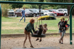 Meghan Sciascia of Vancouver, from left in green, enjoys playtime at Heritage Park with her daughter, Paloma, 4, as well as Ricky Thayer-Daughtery, 5, of Camas and his mom, Faith, on July 31. The city of Camas is partnering with a crowd-tracking company to get an accurate count of parks visitors. (Photos by Amanda Cowan/The Columbian)