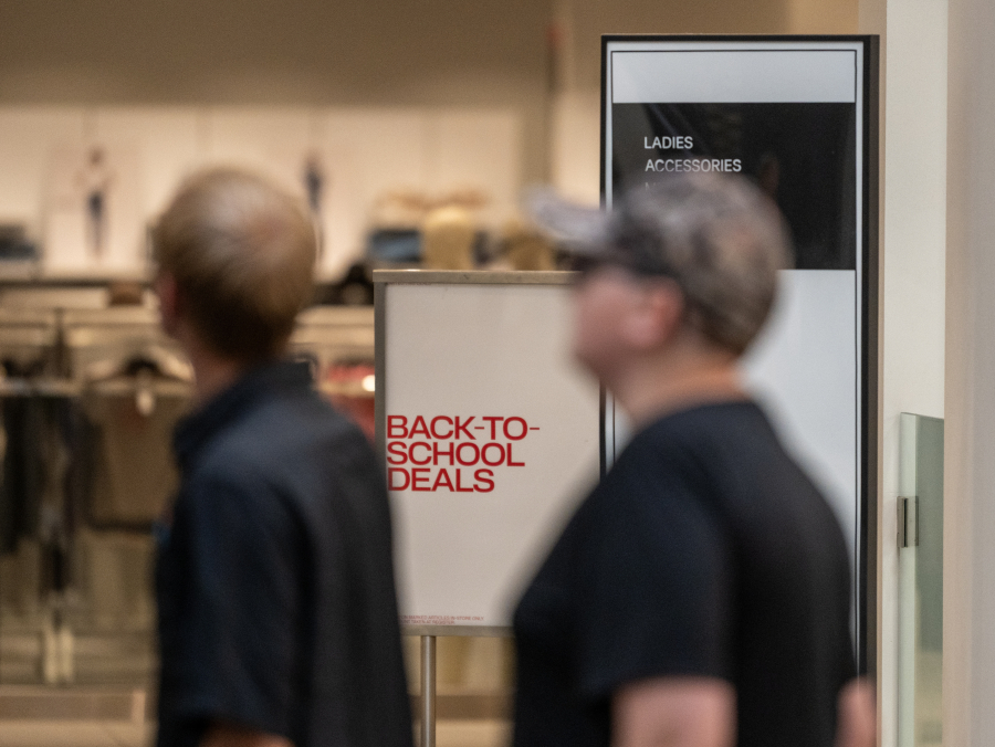 Shoppers pass the entrance of H&M inside Vancouver Mall on Wednesday. The National Retail Federation found half of back-to-school shoppers surveyed were starting shopping early out of concern about how tariffs would impact their shopping for the school year.