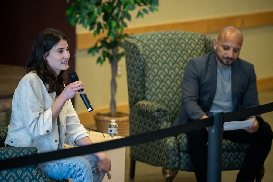 U.S. Rep. Marie Gluesenkamp Perez, D-Skamania, left, answers a question Wednesday at a town hall at the Battle Ground Event Center, while event moderator Wil Fuentes, a Clark County Council member, glances at audience members&rsquo; written questions. (Taylor Balkom/The Columbian)