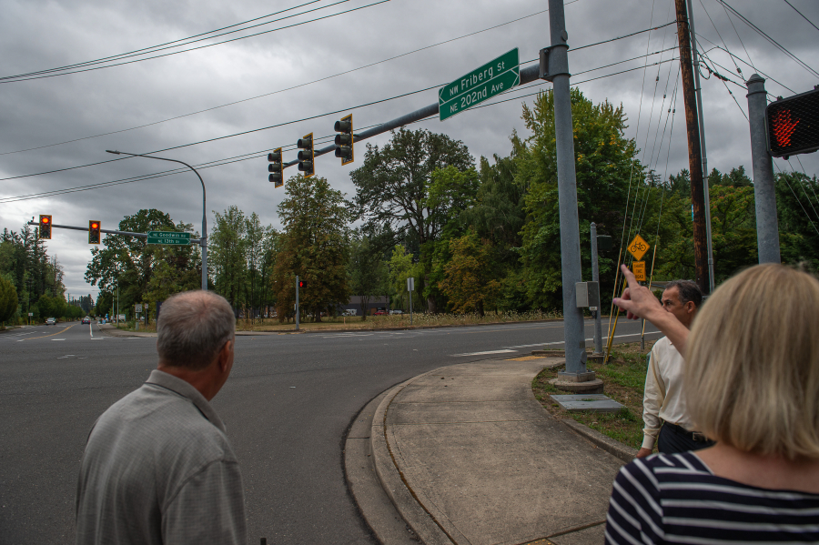 Camas resident Karin Nosrati, right, points out the street changes necessary to install a gas station near the corner of Northeast 13th Street and Northwest Friberg-Strunk Street in northeast Camas on Friday. A Clark County Superior Court judge ruled in favor of a group of Camas residents, who sued the city of Camas over a permit given to new construction of a gas station in their neighborhood. (Photos by James Rexroad/for The Columbian)