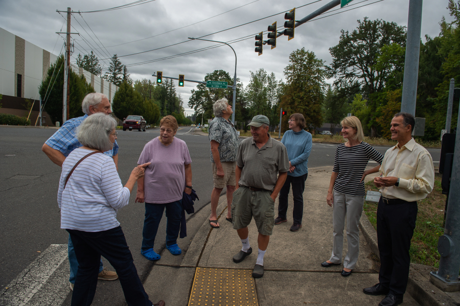From left, Camas residents Ruth and Tom Small, Kalene and Ed Stengel, Russell Wegner, Joan Rickard, and Karin and Randy Nosrati stand near the corner of Northeast 13th Street and Northwest Friberg-Strunk Street in northeast Camas on Friday. (James Rexroad/ for The Columbian)