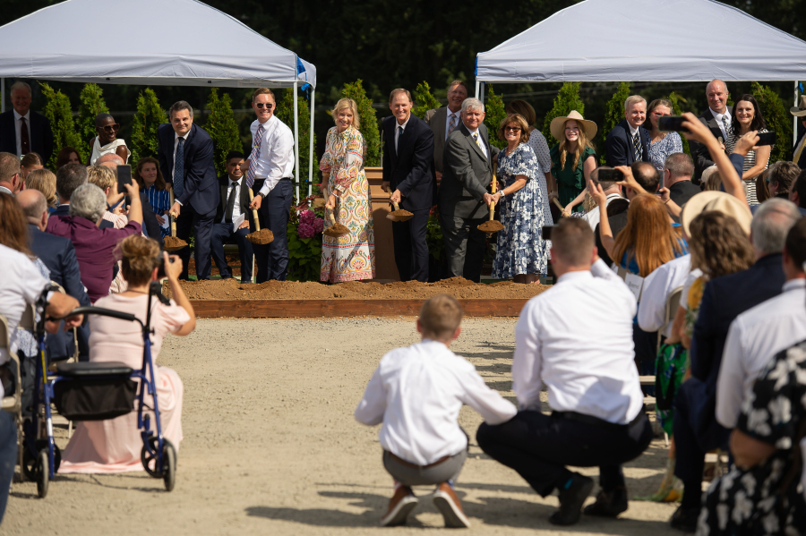 Latter-day Saints scoop shovels of ceremonial dirt during a Saturday groundbreaking ceremony for the Vancouver Washington Temple.