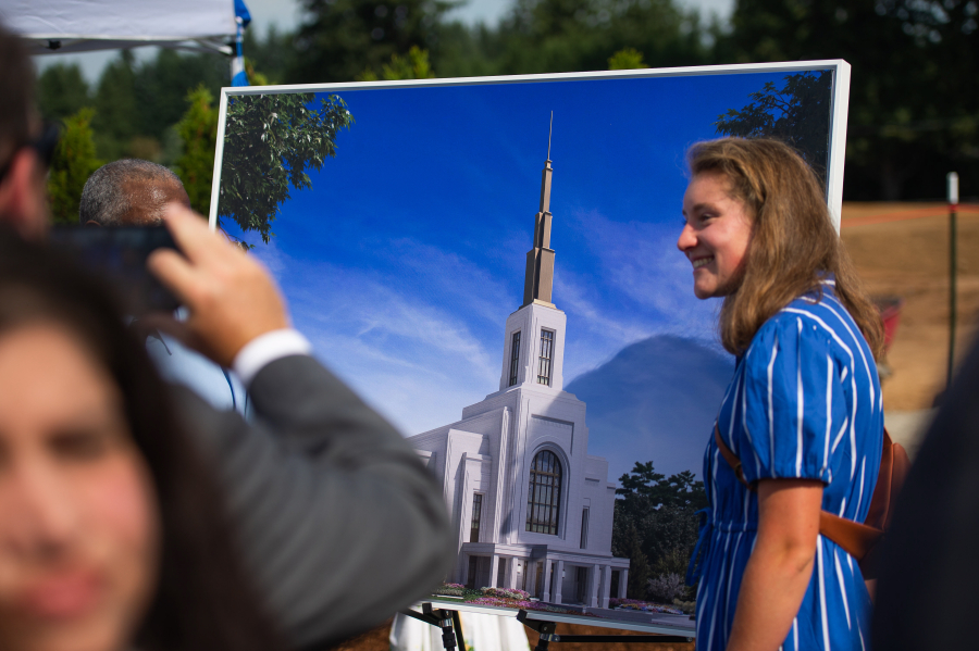 Abigail Grant, soon to be on a mission to Peru, poses for a photo in front of the planned temple. The Church of Jesus Christ of Latter-day Saints held a groundbreaking ceremony for the Vancouver Washington Temple, the sixth temple in Washington. The temple will be built on a 15.11-acre plot on the Vancouver-Camas border. It will be 43,000 square feet, and several stories tall. (James Rexroad/for The Columbian)