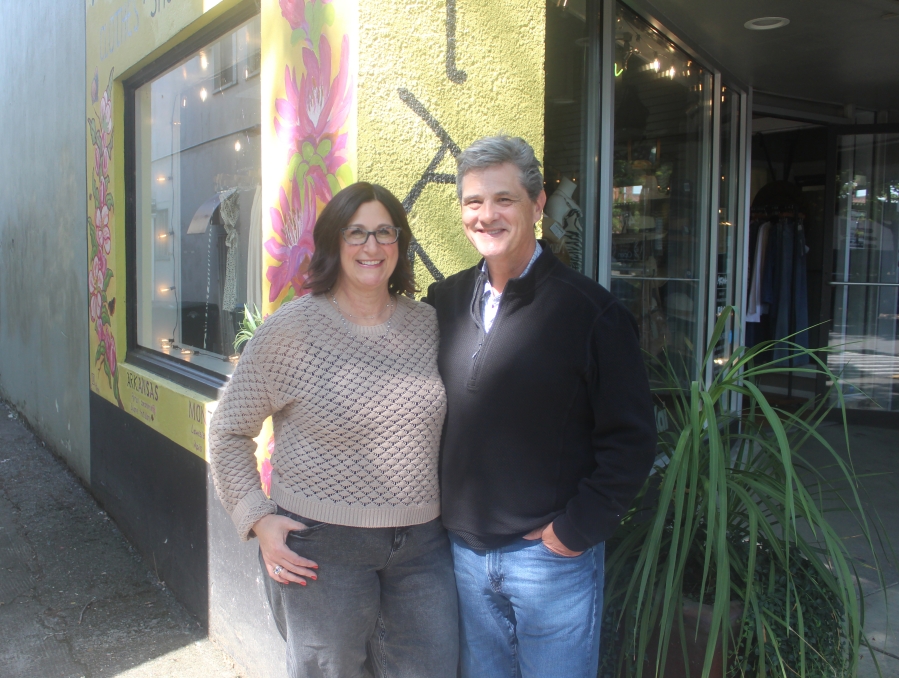 Arktana owners Ann and Bill Matthews stand in front of the women&rsquo;s boutique in downtown Camas on Friday, Aug. 29, 2025. (Photos by Doug Flanagan/The Columbian)