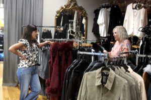 Katie Thomas, left, manager of the Arktana women’s boutique in downtown Camas, helps a customer Friday. (Doug Flanagan/The Columbian)