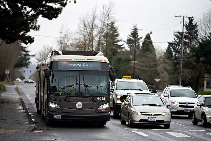 A C-Tran bus joins a crowd of motorists while waiting at a red light at the intersection of Southeast Hearthwood and Mill Plain boulevards in February. Clark County&rsquo;s small cities are questioning whether they get their money&rsquo;s worth out of C-Tran. (Amanda Cowan/The Columbian files)