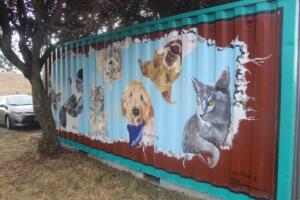 The West Columbia Gorge Humane Society commissioned Washougal artist Travis London to paint a mural depicting pets of the organization’s supporters on one of its Conex buildings. (Photos by Doug Flanagan/The Columbian)