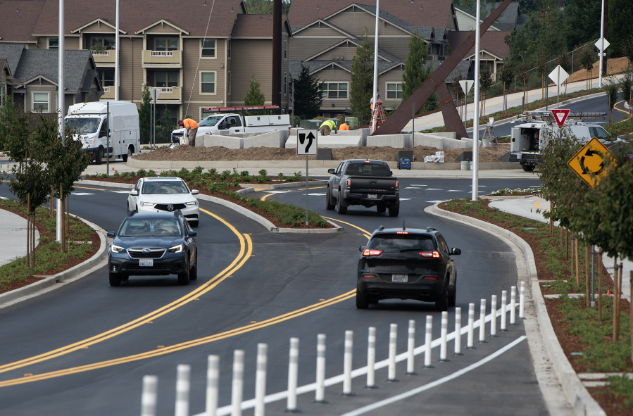 Drivers navigate a new roundabout as construction work on Southeast First Street is done and the road has reopened, as seen Wednesday morning. (Amanda Cowan/The Columbian)